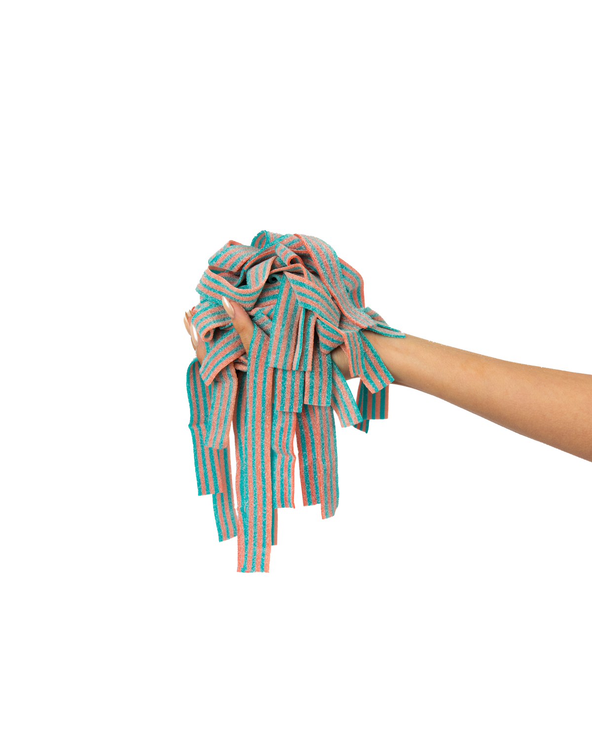 A hand holding a bundle of colorful, striped gummy candies against a gradient background of pink and blue. The candies are predominantly red, white, and blue with a slightly textured appearance.