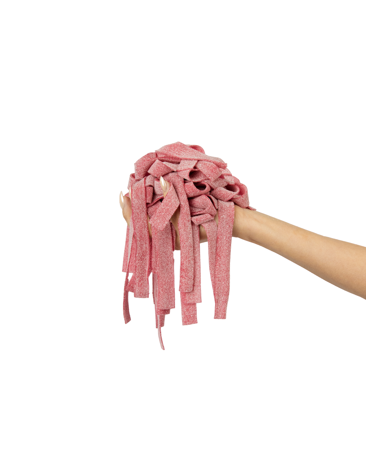 A hand is holding a tangled, ribbon-like object that's pink with speckles and extends downward with several loose strands. The background is a solid, deep red color.