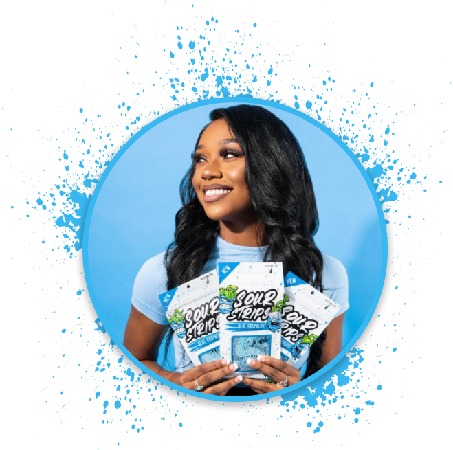 A woman with long, dark hair smiles while holding several packets of "Sour Strips" candy. The background is light blue, and there is a blue and black splatter effect framing the circle around her. The packets have colorful designs.